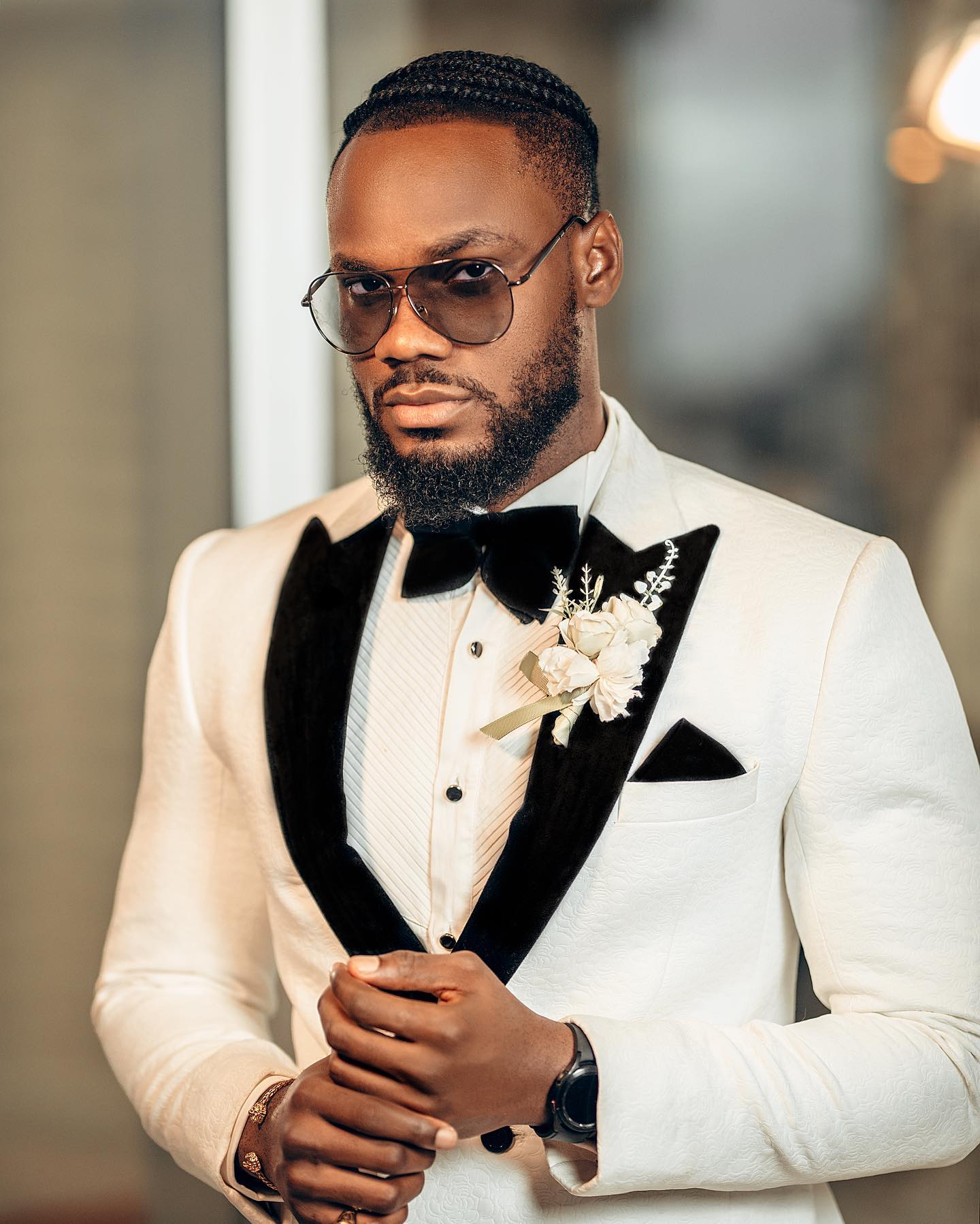 Single-breasted Crisp White Suit with black velvet lapel and matching black pants.