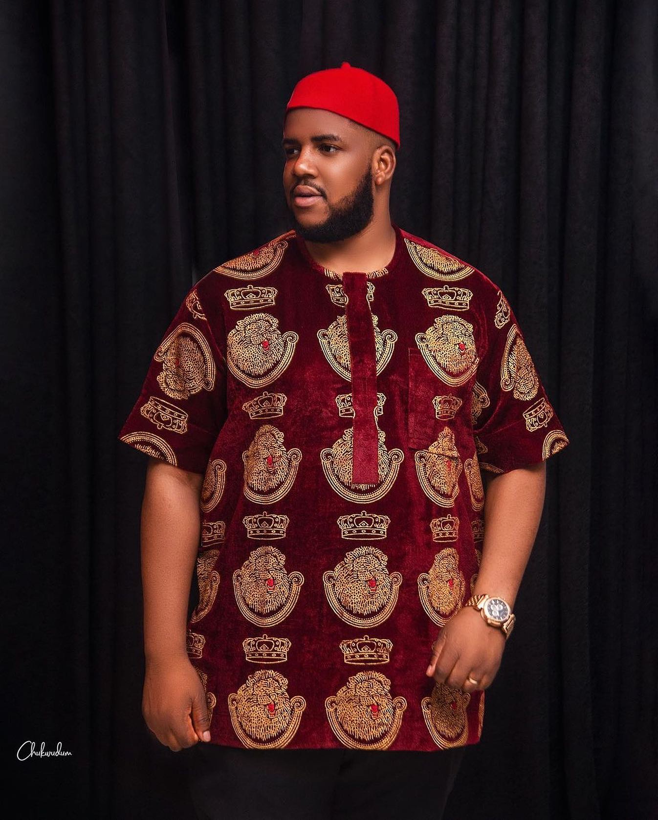 Red Velvet Isiagu Top with black pants and a red chief cap